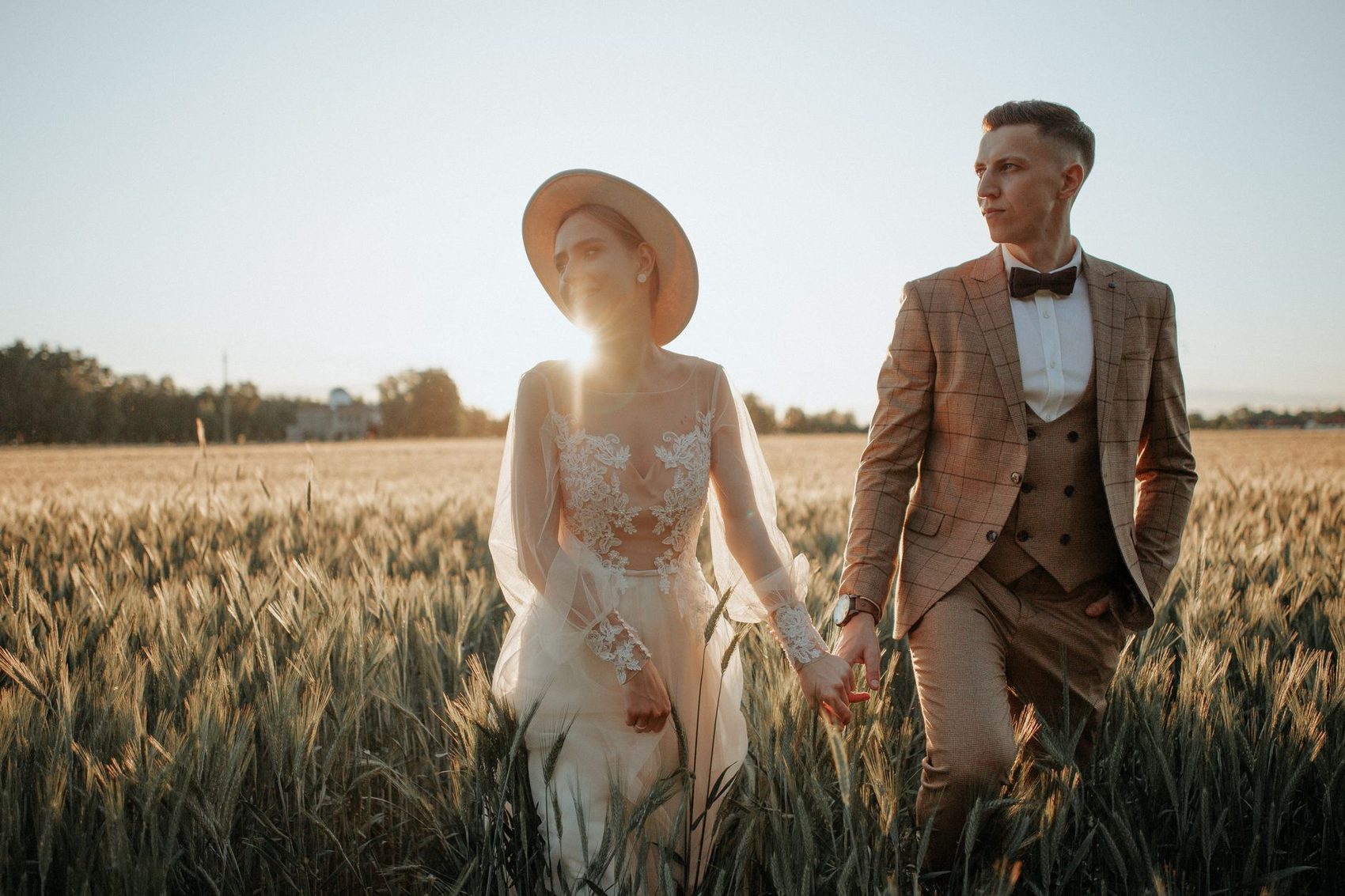 Couple walking through open country at golden hour